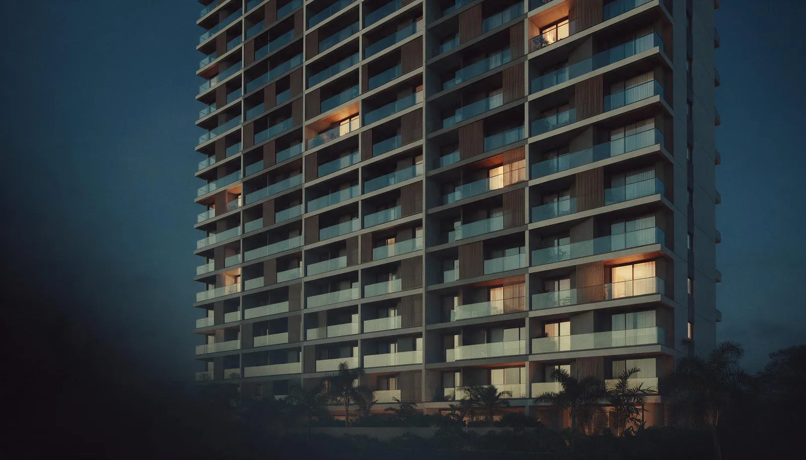 Fachada de edifício residencial moderno com varandas iluminadas ao anoitecer